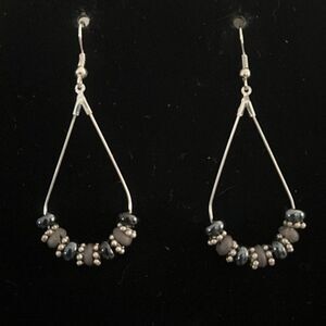 Handcrafted silver tone earrings with black, grey and silver beading.